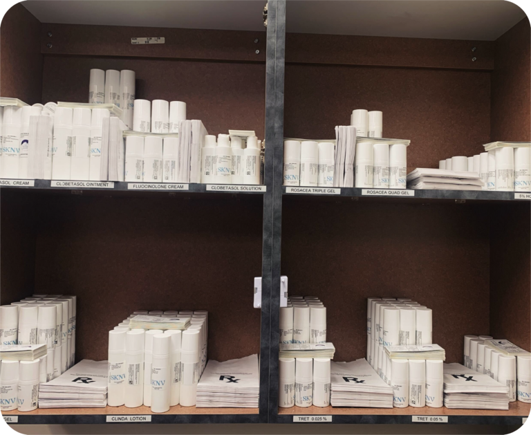 Organized shelves displaying SKNV medications, including creams, gels, and lotions, labeled for easy in-office dispensing