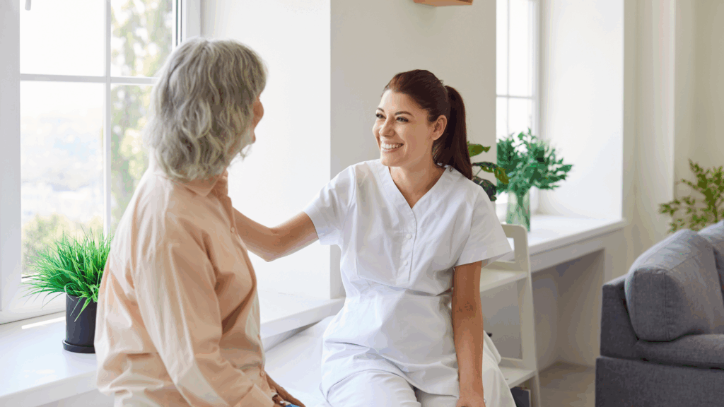 Dermatology provider speaking with an older patient about persistent facial redness and rosacea treatment options.
